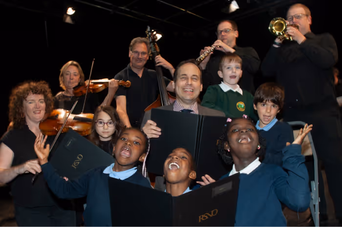 A picture of happy students and musicians holding instruments at the Lemon Tree.