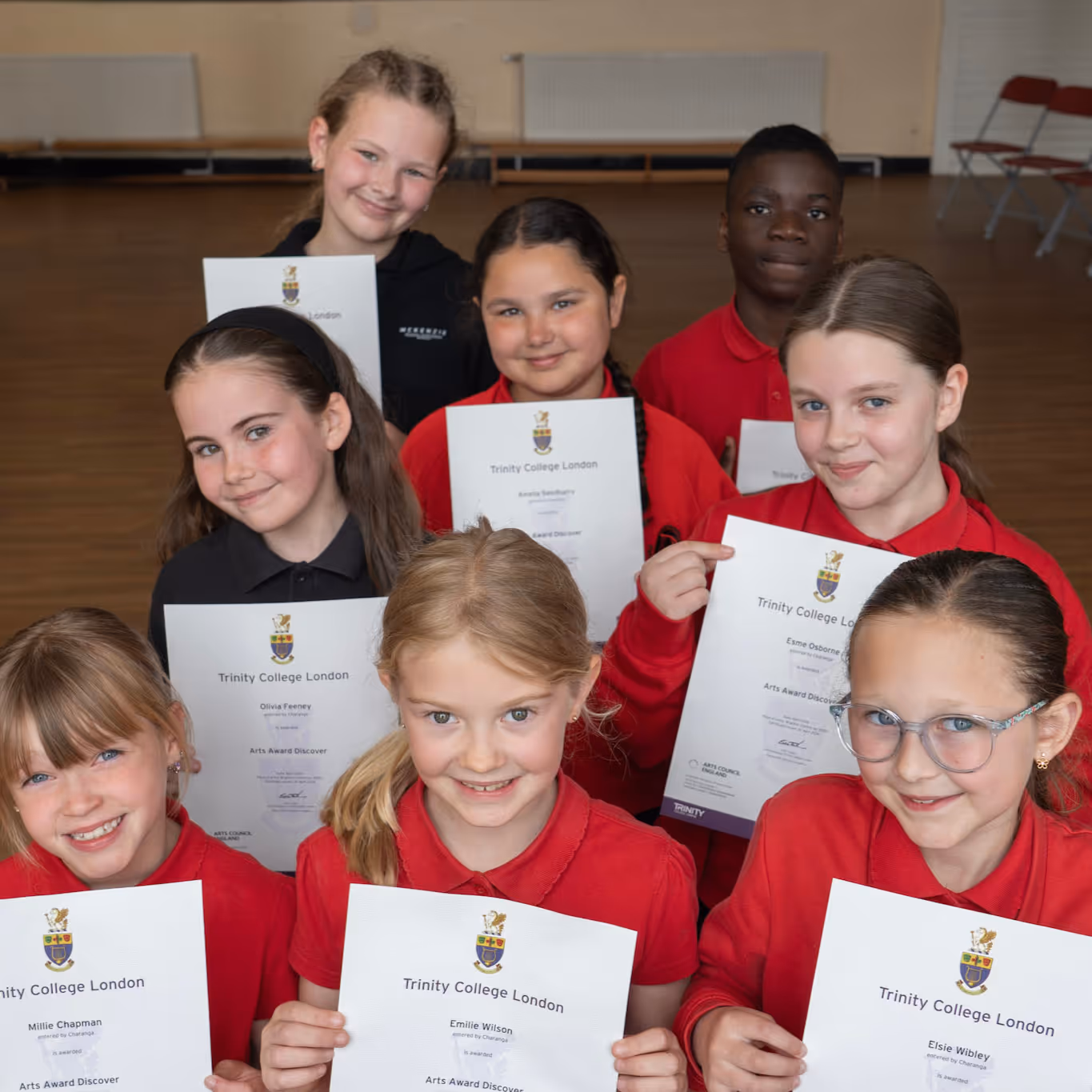 Children holding Arts Award Certificates