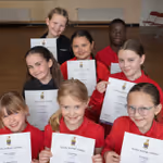 Children holding Arts Award Certificates